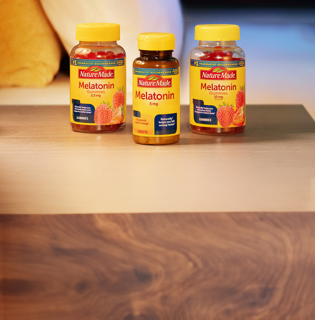 Nature Made® Melatonin supplement containers on nightstand